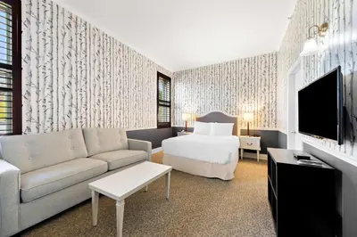 a hotel room with a bed and a couch at The Arlington Hotel - BW Signature Collection in Paris
