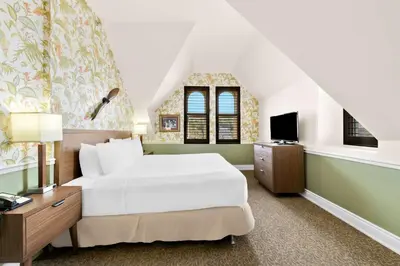 a bedroom with a white bed and a tv at The Arlington Hotel - BW Signature Collection in Paris