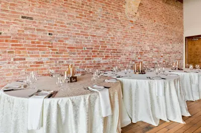 a group of tables with white tablecloths and wine glasses at The Arlington Hotel - BW Signature Collection in Paris
