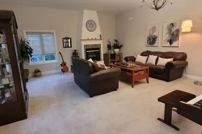 a living room with two couches and a fireplace at Summer Getaway with Pool and Nearby Attractions in Cobourg