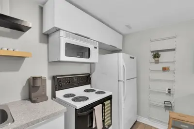 a kitchen with a stove and a microwave at 6BR house near Shops, Transit, Hwy and GO in Mississauga