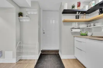a kitchen with white cabinets and a black rug at 6BR house near Shops, Transit, Hwy and GO in Mississauga