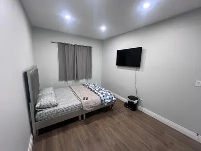 a bedroom with a bed and a flat screen tv at Bb11 Private Bathroom Room In Cambridge in Cambridge