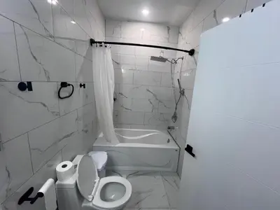 a white bathroom with a toilet and a bath tub at Bb11 Private Bathroom Room In Cambridge in Cambridge