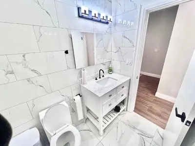 a white bathroom with a toilet and a sink at Private Room In Cambridge B9 in Cambridge