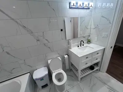 a bathroom with a toilet and a sink and a mirror at Private Room In Cambridge B4 in Cambridge