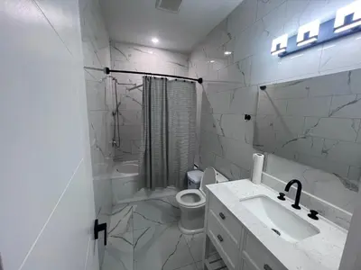 a white bathroom with a sink and a toilet at Private Room In Cambridge B4 in Cambridge