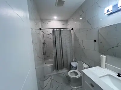 a white bathroom with a toilet and a sink at Private Room In Cambridge B4 in Cambridge