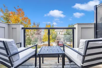 a patio with two chairs and a table on a balcony at Cozy 3BR Home with Parking Near Kitchener Attractions in Kitchener