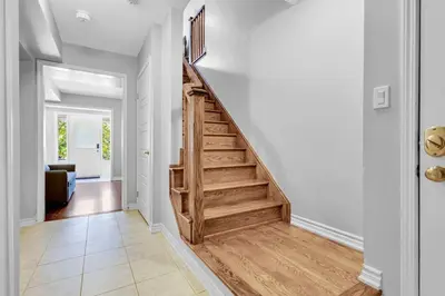 a hallway with a wooden staircase in a home at Cozy 3BR Home with Parking Near Kitchener Attractions in Kitchener
