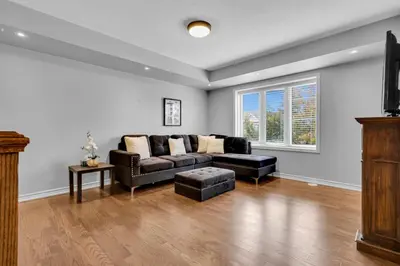a living room with a couch and a table at Cozy 3BR Home with Parking Near Kitchener Attractions in Kitchener