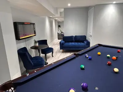 a living room with a pool table and chairs at Ravine Retreat - 3RM Suite, 2BD, 1 WR, Pool, Sauna in Whitby