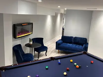 a living room with a pool table and a tv at Ravine Retreat - 3RM Suite, 2BD, 1 WR, Pool, Sauna in Whitby