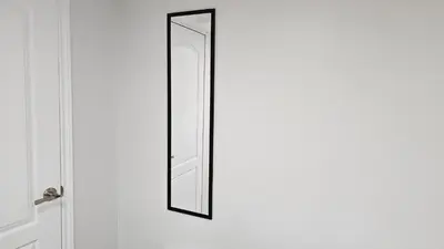 a mirror on the door of a bathroom at Garden Ave Home 1mins to HWY 403 in Brantford