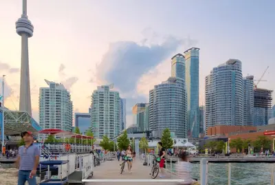 people walking on a pier in a city with tall buildings at Central Downtown Toronto - Trinity Bellwood Park in Toronto
