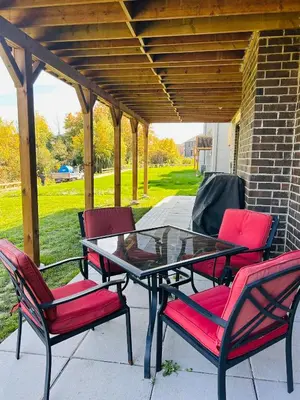 a patio table and four chairs under a pergola at Rita's Kunjo - 2BR, 3BD, 2WR, Full Ktchn, Living in Whitby