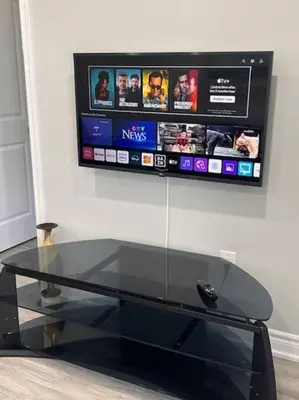 a glass table with a tv on the wall at Rita's Kunjo - 2BR, 3BD, 2WR, Full Ktchn, Living in Whitby