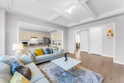 a living room with a couch and a table at Executive Brand New House 5 Bedrooms and Office in Cambridge