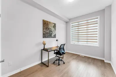 an empty room with a desk and a window at Executive Brand New House 5 Bedrooms and Office in Cambridge