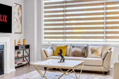 a living room with a couch and a coffee table at Executive Brand New House 5 Bedrooms and Office in Cambridge
