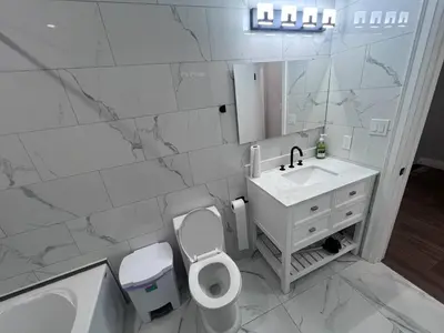 a bathroom with a toilet and a sink and a mirror at B12 Private Room In Cambridge in Cambridge