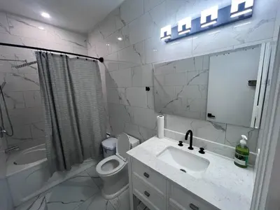 a bathroom with a sink and a toilet and a mirror at B12 Private Room In Cambridge in Cambridge