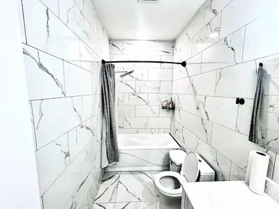 a white bathroom with a toilet and a sink at Private Room In Cambridge B8DW in Cambridge