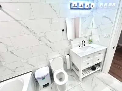 a white bathroom with a toilet and a sink at Private Room In Cambridge B8DW in Cambridge