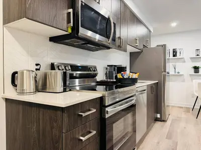 a kitchen with stainless steel appliances and a microwave at Luxury Stay Near Niagara Falls in Niagara Falls
