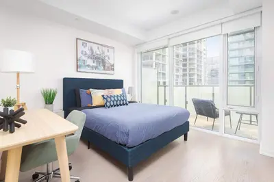 a bedroom with a bed and a table and a desk at 1BR Space - Downtown Toronto in Toronto