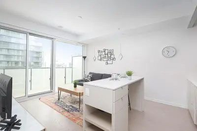 an office with a white desk and a large window at 1BR Space - Downtown Toronto in Toronto