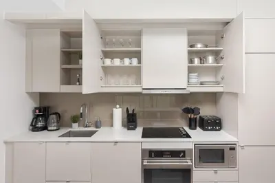 a white kitchen with white cabinets and appliances at 1BR Space - Downtown Toronto in Toronto