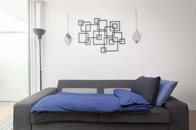 a bedroom with a bed with blue pillows on it at 1BR Space - Downtown Toronto in Toronto