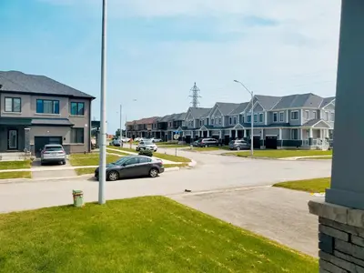 a car parked in a parking lot in a residential neighborhood at New 3-BR Home Near Niagara Falls with King Bed 75 Inch TV and Free Parking in Thorold