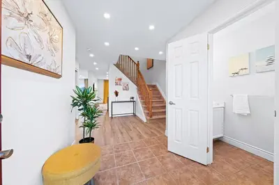 a hallway with a white door and a staircase at Stylish and Cozy 4 bedroom House in Barrie