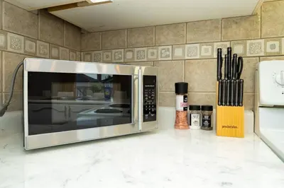 a microwave sitting on a counter in a kitchen at Stylish and Cozy 4 bedroom House in Barrie