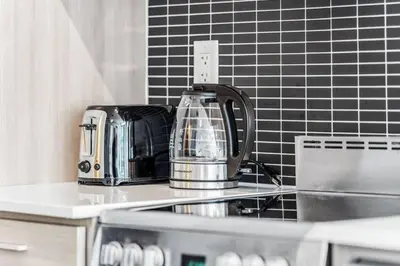 a kitchen counter with a toaster and a tea kettle at Stylish 2BR Urban Escape, BBQ, Private Terrace in Toronto
