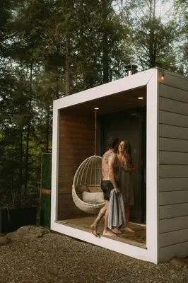 a man and a woman standing inside of a play house at Aux Box Muskoka Modern Muskoka Bunkie in Huntsville