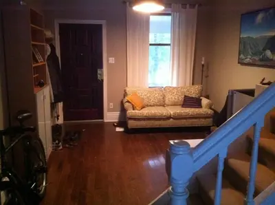 a living room with a couch and a window at Lovely home in Leslieville in Toronto
