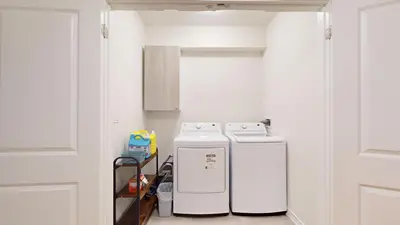a kitchen with two refrigerators sitting next to a door at New Custom-built House Close to Rogers Stadium in Toronto