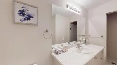 a white bathroom with a sink and a mirror at New Custom-built House Close to Rogers Stadium in Toronto