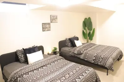 a bedroom with two beds and a couch at Brand New Luxurious 4B Townhouse in Oshawa