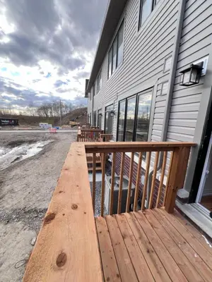 a wooden deck in front of a building at Brand New Luxurious 4B Townhouse in Oshawa