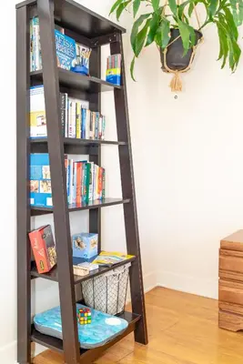 a book shelf filled with books at Room in cozy house close to Lawrence Ave, WiFi, parking in Toronto