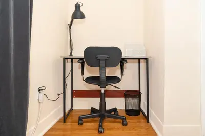 a desk with a chair and a lamp at Room in cozy house close to Lawrence Ave, WiFi, parking in Toronto