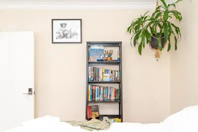 a book shelf filled with books in a bedroom at Room in cozy house close to Lawrence Ave, WiFi, parking in Toronto