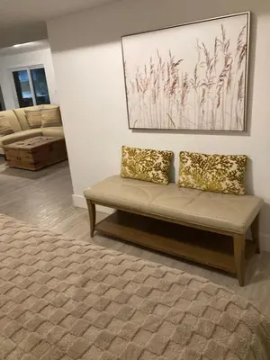 a couch with two pillows sitting in a living room at Treetop Suite in Haliburton