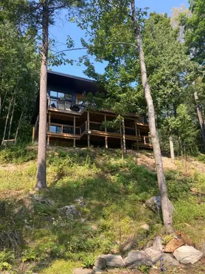 a house in the woods with trees at Treetop Suite in Haliburton