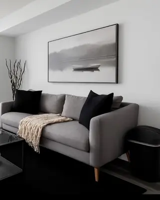 a couch in a living room with a picture on the wall at Upscale 1 Bed & Den Downtown Toronto in Toronto
