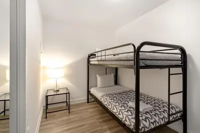 a bedroom with two bunk beds and a lamp at Upscale 1 Bed & Den Downtown Toronto in Toronto